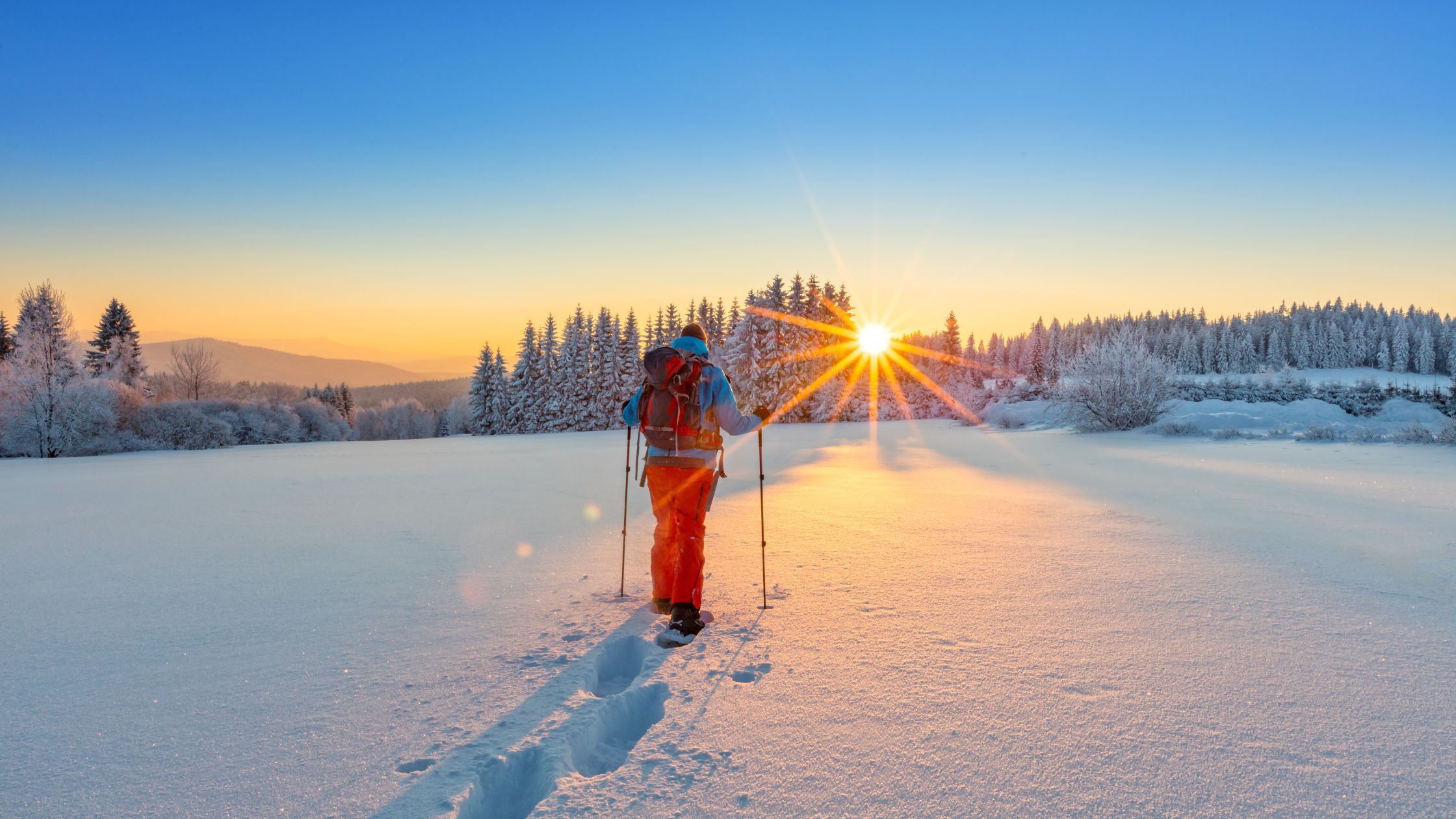 Snowshoeing on a frozen lake in winter.