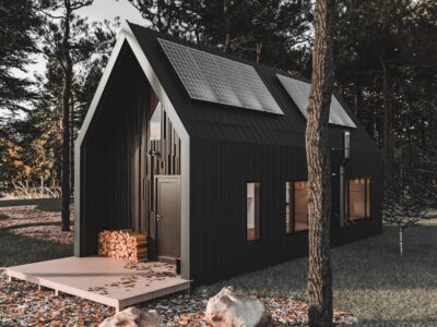 black, wooden A-frame cabin in the woods with solar panels on the roof