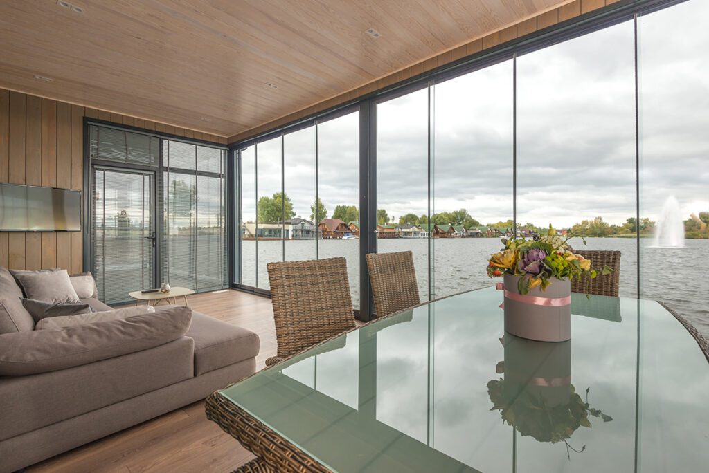 Interior of a vacation rental property with large windows showcasing the lakeside view.