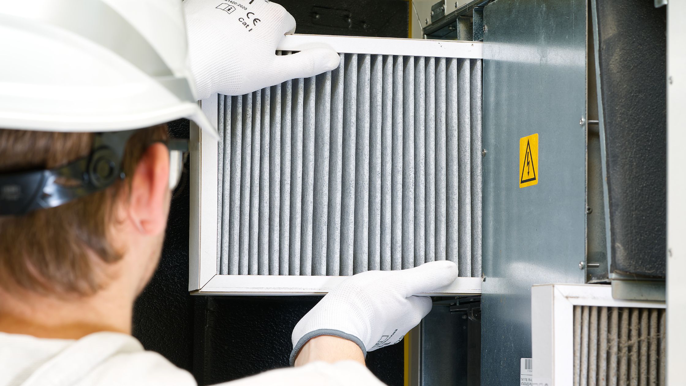 Furnace filter being changed by an HVAC technician.