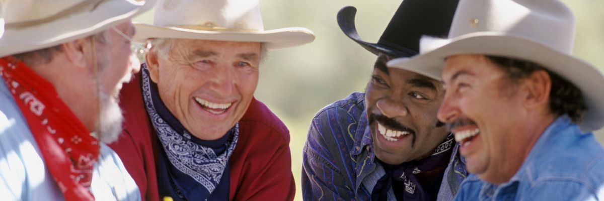 Cowboys laughing in a group