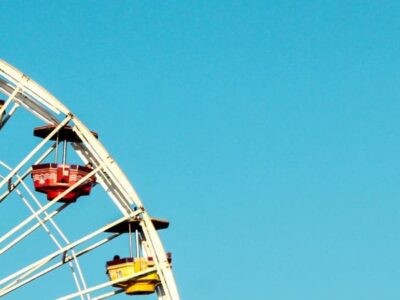 Ferris wheel with a bright blue sky.