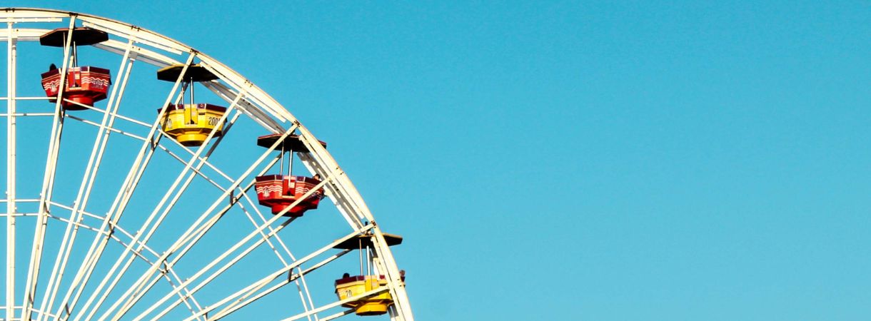 Ferris wheel with a bright blue sky.