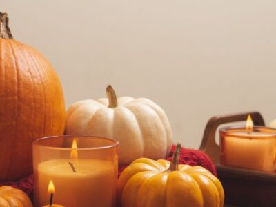 Pumpkins sitting stylishly on the table with candles