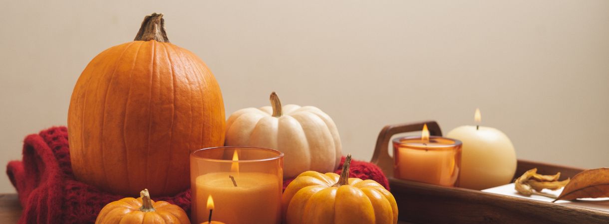 Pumpkins sitting stylishly on the table with candles